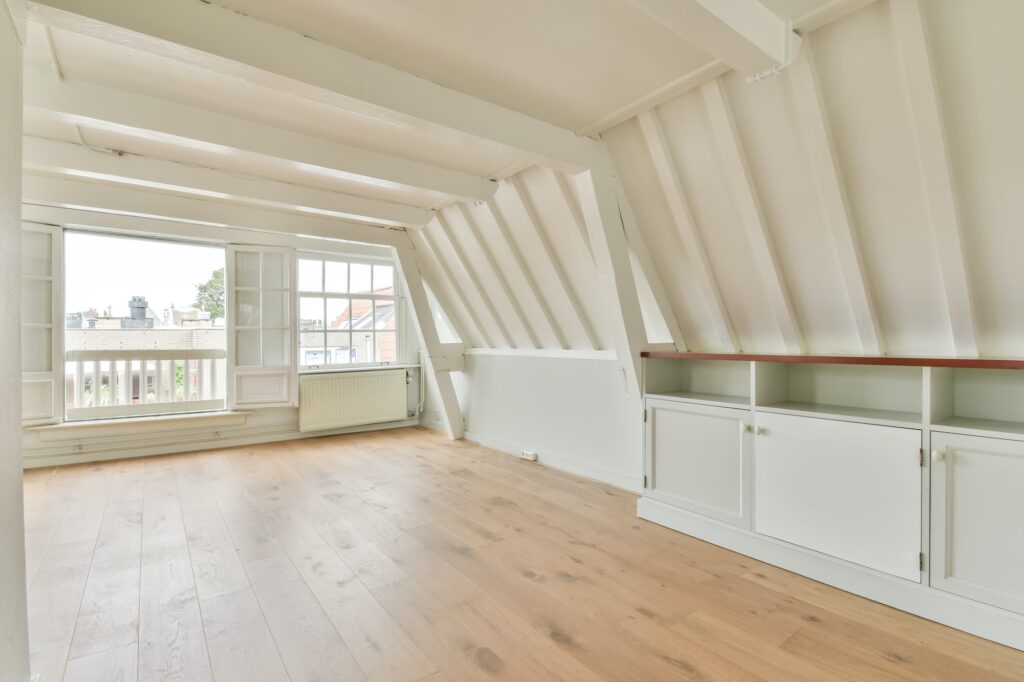 Room with large windows and parquet flooring