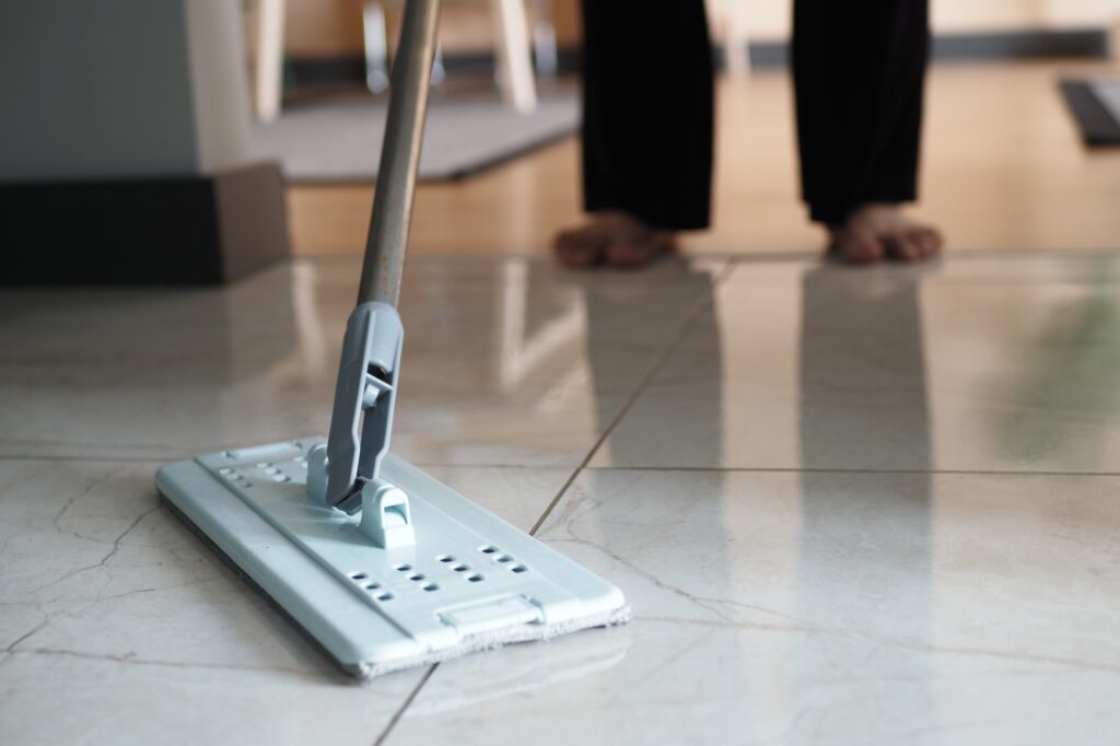 cleaning tiles floor with mop