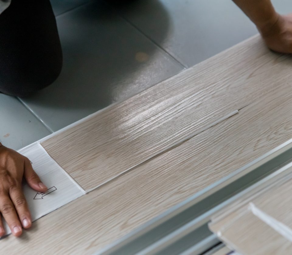 Vinyl floor installation, worker, DIY at home.